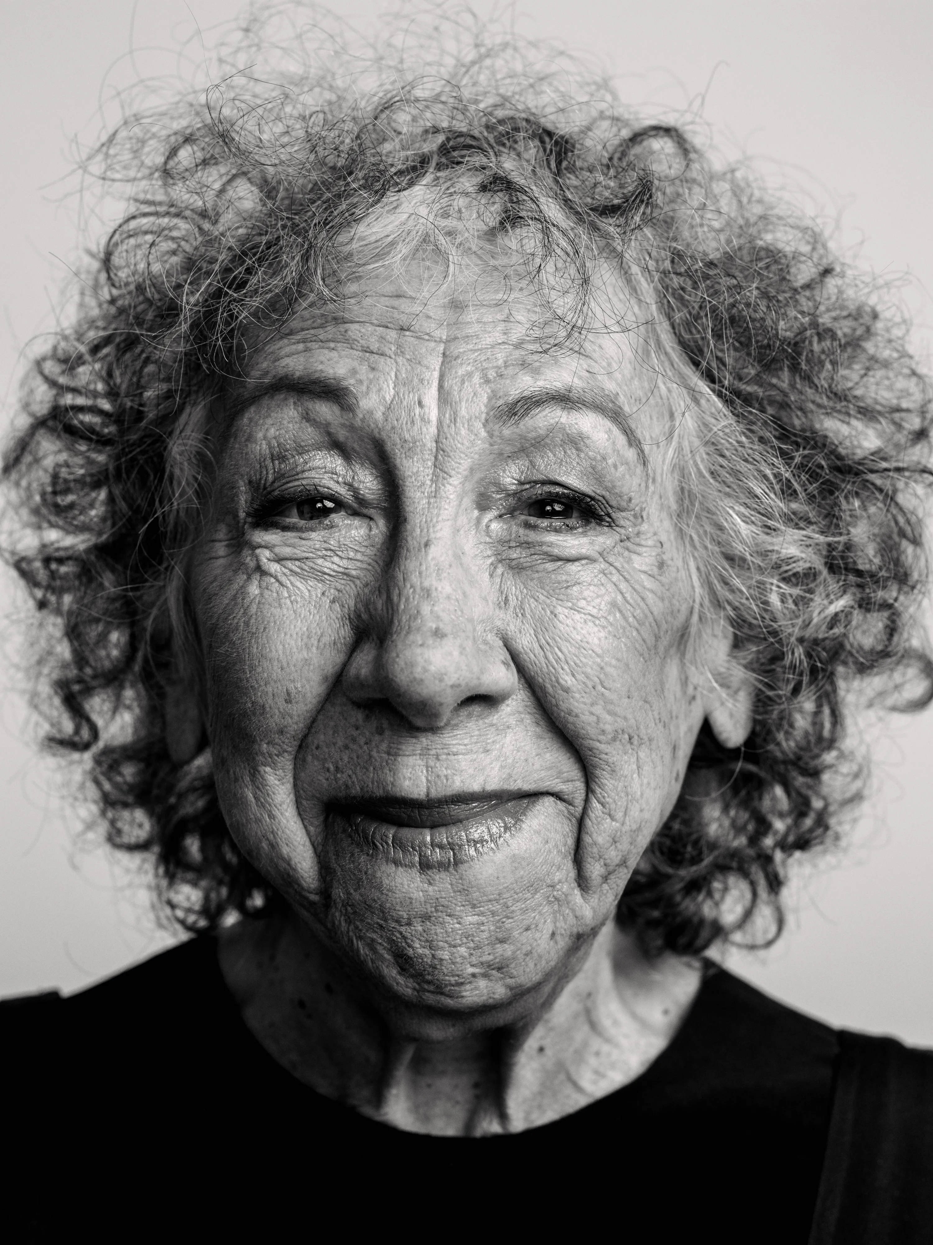 Portrait of young woman in front of white background